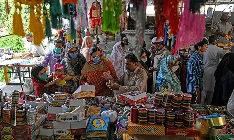 Customers shop for bangles at a market after the government eased the nationwide lockdown imposed as a preventive measure against the coronavirus, in Islamabad on May 9, 2020. &mdash; AFP/File