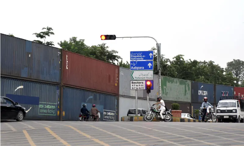THE entrance to the capital&rsquo;s high security Red Zone has been sealed off with containers ahead of the PTI and JI&rsquo;s planned protest marches.&mdash;Tanveer Shahzad / White Star