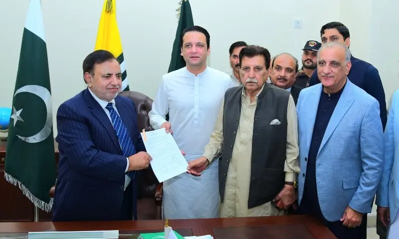 AJK Prime Minister Iftikhar Gillani (centre) and former premier Raja Farooq Haider submit the nomination papers of the PML-N's Dr Najeeb Naqi (R) as his seconder and proposer, respectively, to AJK Chief Election Commissioner (Retd) Justice Ghulam Mustafa Mughal at his office in Muzaffarabad on September 19, 2026. — Photo by author AJK Prime Minister Iftikhar Gillani (centre) and former premier Raja Farooq Haider submit the nomination papers of the PML-N's Dr Najeeb Naqi (R) as his seconder and proposer, respectively, to AJK Chief Election Commissioner (Retd) Justice Ghulam Mustafa Mughal at his office in Muzaffarabad on September 19, 2026. — Photo by author