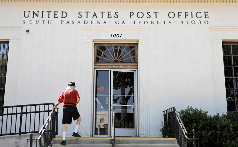 A customer enters a United States Post Office in South Pasadena, California. The United States Postal Service announced last week it has stopped work on a controversial computer system which was a key component to President Trump’s effort to limit voting by mail after the US Supreme Court blocked the executive order.—AFP A customer enters a United States Post Office in South Pasadena, California. The United States Postal Service announced last week it has stopped work on a controversial computer system which was a key component to President Trump’s effort to limit voting by mail after the US Supreme Court blocked the executive order.—AFP