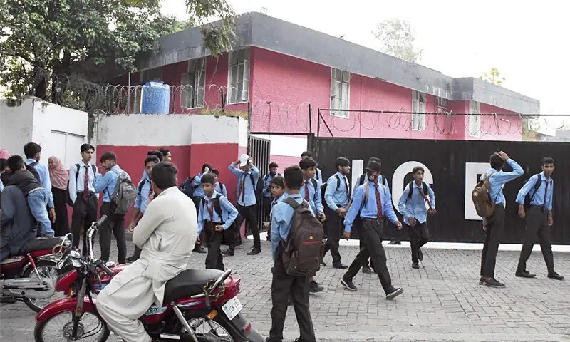 Students come out of Islamabad College for Boys, G-6/3, after the end of classes on Monday. The capital administration has decided to close 24 educational institutions from today (Tuesday) as police personnel are being accommodated on their premises amid preparations for planned political marches and protests in Islamabad. &mdash; Photo by Mohammad Asim