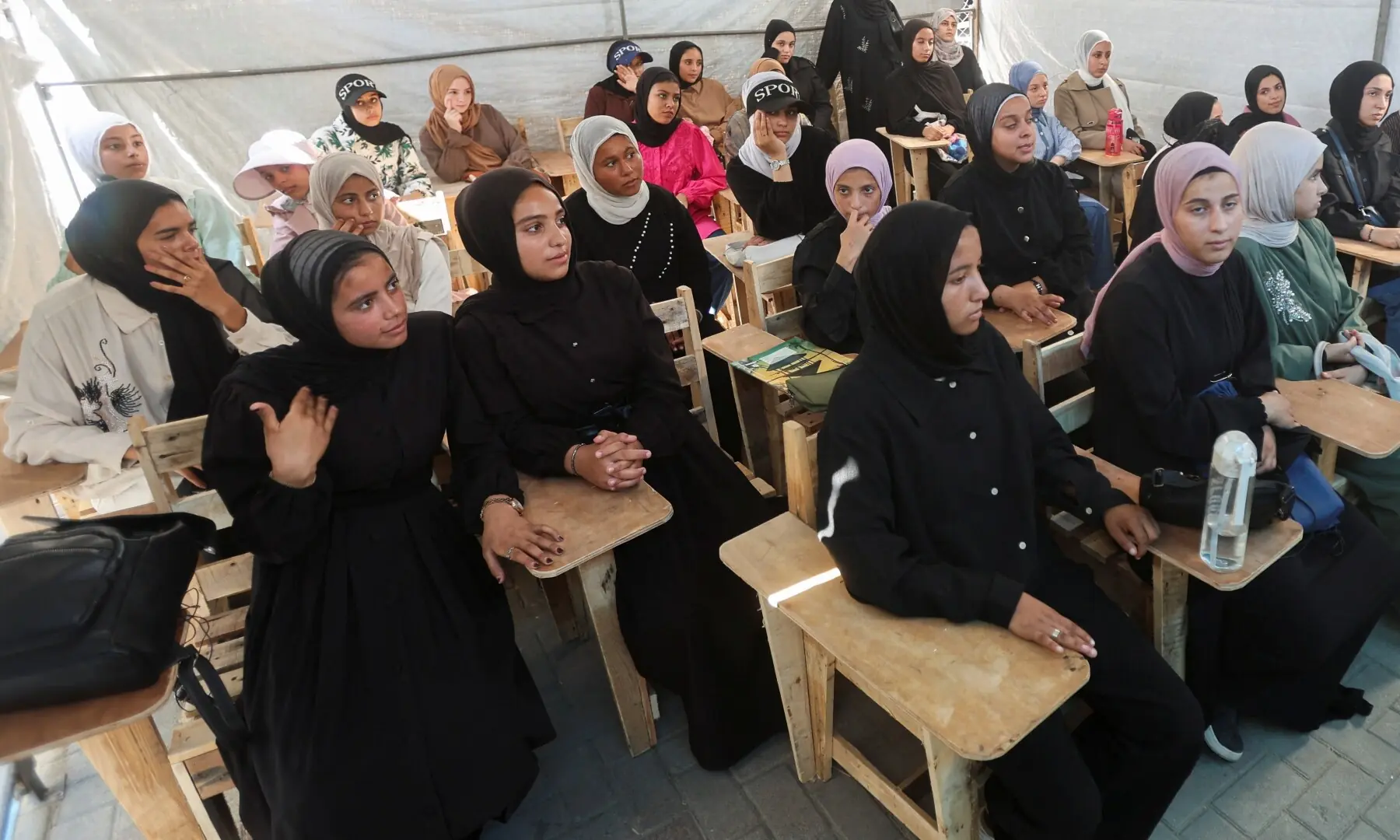 Displaced Palestinian student Samar Abu Salmi, 15, sits with other female students inside a tent classroom in Khan Younis, in the southern Gaza Strip on September 20, 2026. —Reuters