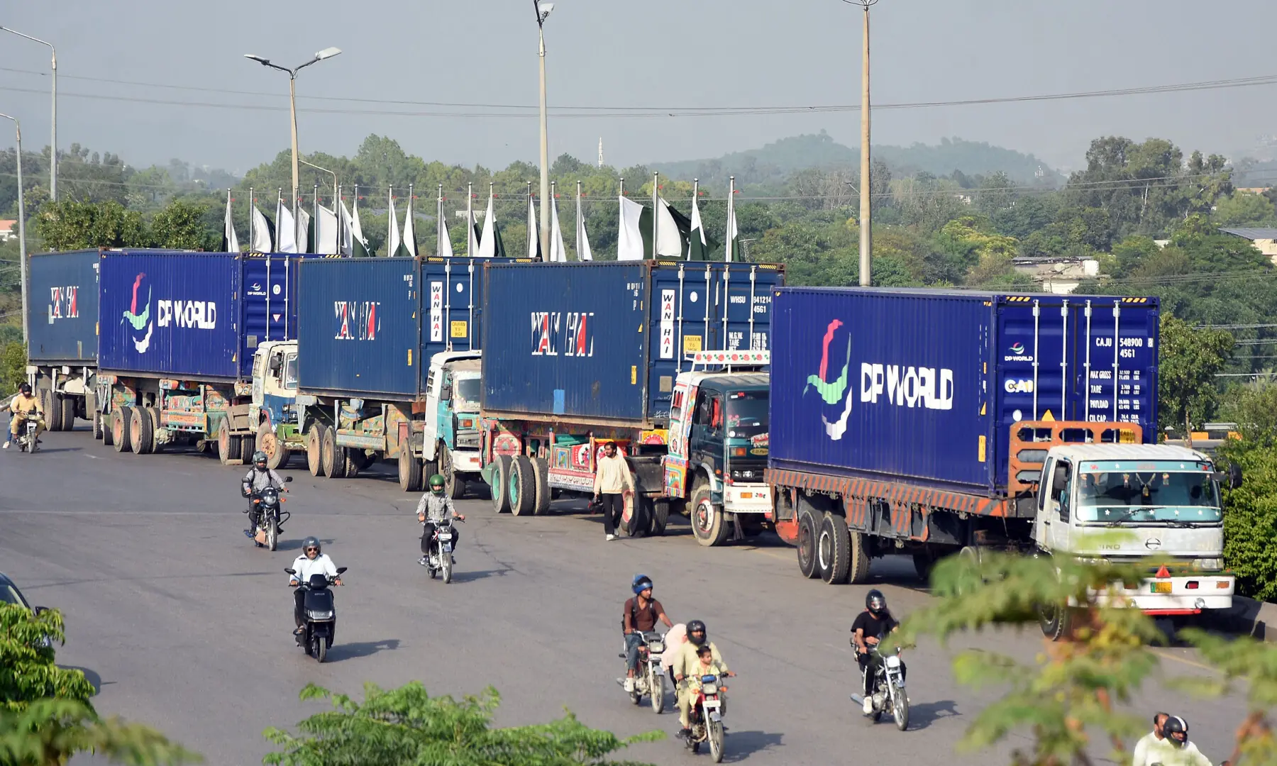 A view on Sept 20, 2026 of trailers parked at Islamabad's Faizabad interchange bridge loaded with shipping containers to block roads. &mdash; ONLINE PHOTO by Waseem Khan