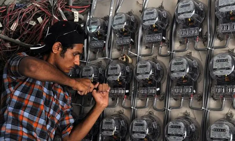A technician checks electricity meters at a residential building. &mdash; AFP/File