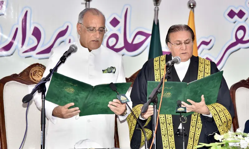 AJK Chief Justice Raja Saeed Akram administers oath to PML-N&rsquo;s Dr Najeeb Naqi as the region&rsquo;s president. &mdash;Photo by the writer