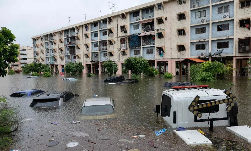 Flood waters submerge cars next to residential buildings after heavy rain in Bangkok on September 26, 2026. &mdash; AFP