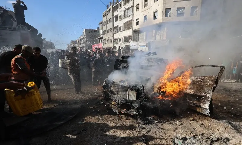 Palestinians attempt to extinguish a burning vehicle that was struck by an Israeli airstrike in Gaza City on September 19.— AFP Palestinians attempt to extinguish a burning vehicle that was struck by an Israeli airstrike in Gaza City on September 19.— AFP