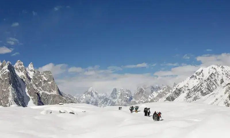 A file photo showing tourists trekking through snow in GB. &mdash; Reuters/File