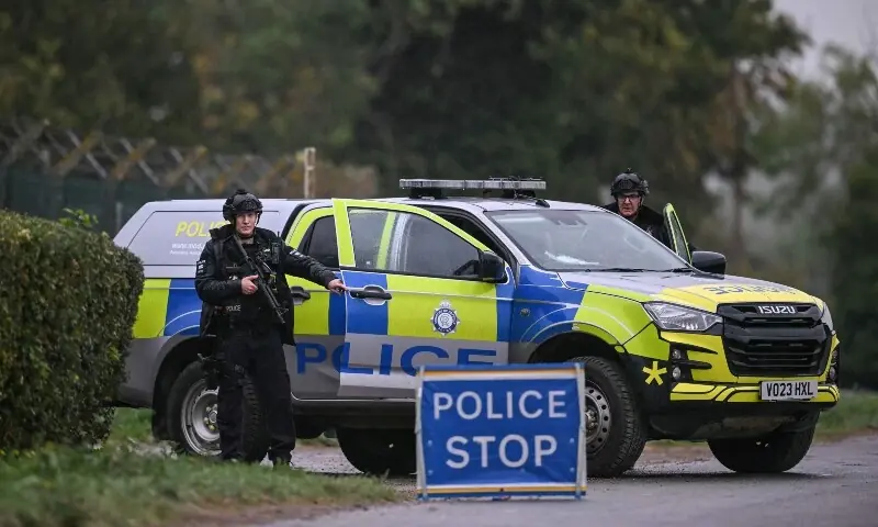 Armed police man a roadblock while posted outside RAF Fairford base in Fairford, south-west England on September 27, 2026, as UK counter-terrorism police investigate an incident near the base in the village of Whelford. &mdash;AFP