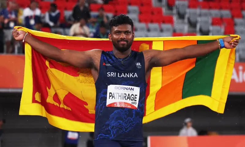 Gold medallist Sri Lanka's Rumesh Pathirage celebrates with a flag after winning the Men's Javelin Throw Final at Paloma Mizuho Sports Park in Nagoya, Japan on September 28. &mdash; Reuters