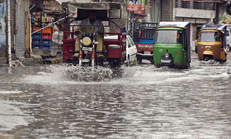 Vehicles ply on the flooded Imam Bara Road following early morning rain in Rawalpindi on Monday. — Online Vehicles ply on the flooded Imam Bara Road following early morning rain in Rawalpindi on Monday. — Online