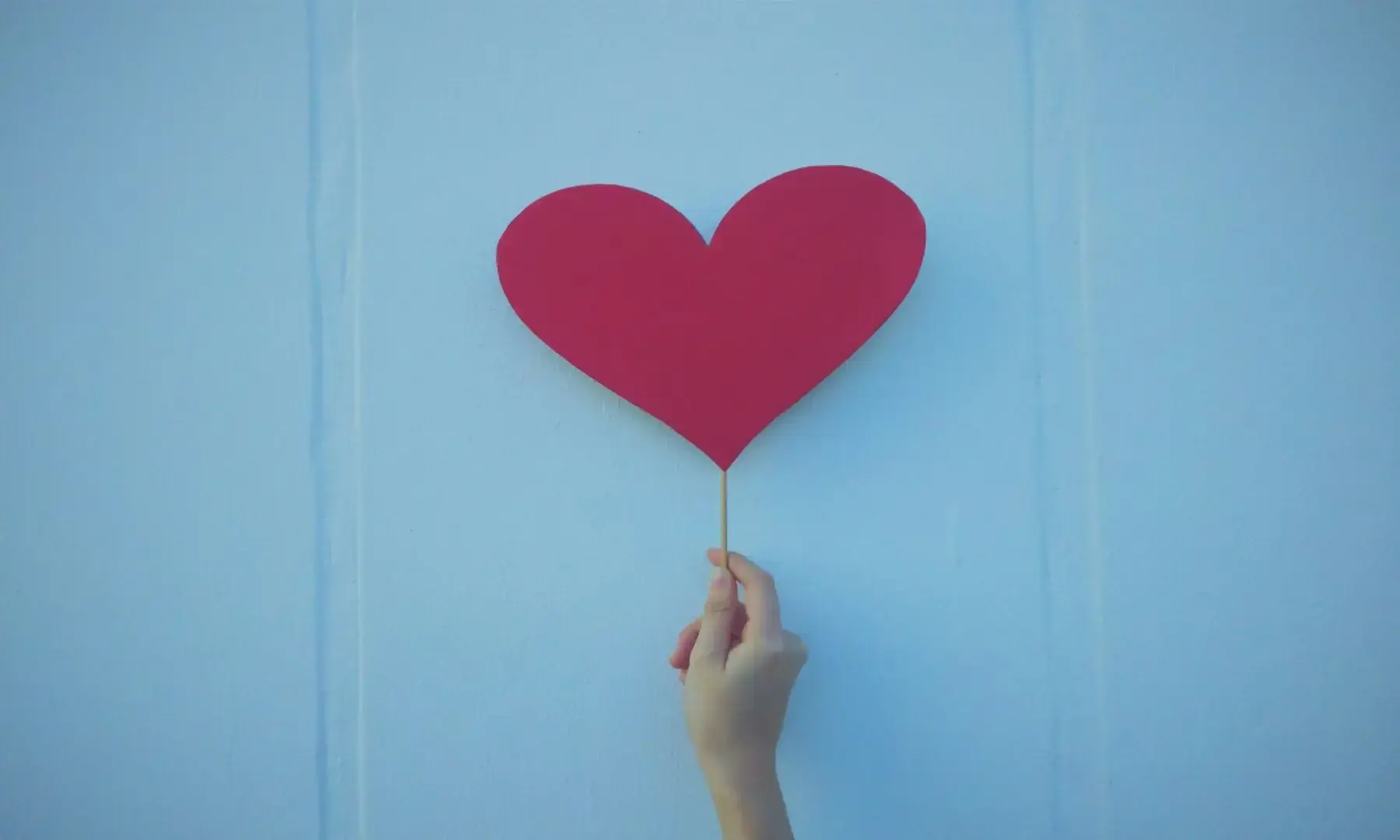 Image showing a person holding a cardboard heart. &mdash; Unsplash/File