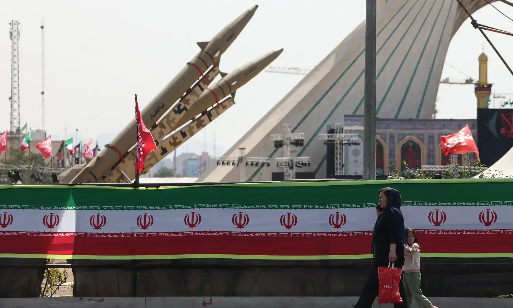 A woman and a child walk past Iranian-made Zolfaghar missiles displayed at Azadi Square in Tehran on July 24, 2026.— AFP/File A woman and a child walk past Iranian-made Zolfaghar missiles displayed at Azadi Square in Tehran on July 24, 2026.— AFP/File