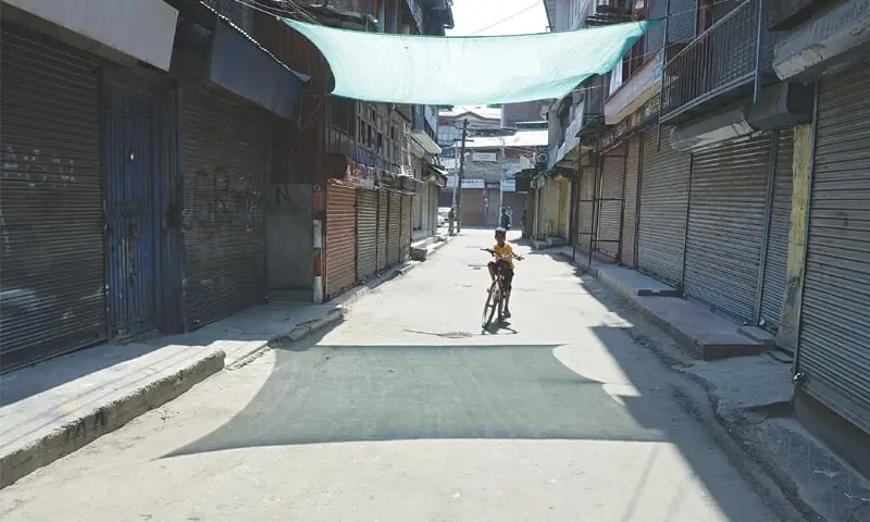 A boy rides a bicycle in a deserted street here on Thursday during a strike called against the killing of civilians in the India-held region, including that of veteran journalist Shujaat Bokhari.—AFP/File A boy rides a bicycle in a deserted street here on Thursday during a strike called against the killing of civilians in the India-held region, including that of veteran journalist Shujaat Bokhari.—AFP/File