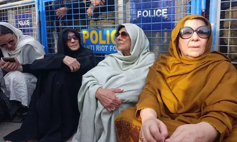 Aleema Khan (C), sister of PTI founder Imran Khan, sits in front of a police barricade in Rawalpindi on December 9, 2025. — X/@PTIofficial Aleema Khan (C), sister of PTI founder Imran Khan, sits in front of a police barricade in Rawalpindi on December 9, 2025. — X/@PTIofficial
