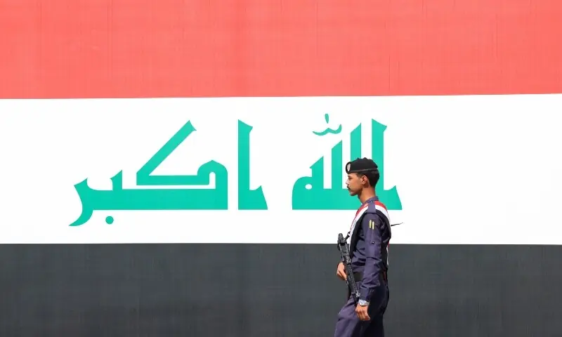 A member of the Iraqi security forces walks on the road as they celebrate the withdrawal of US-led coalition forces from Iraq, ending a military presence that began after the 2003 US-led invasion, in Baghdad, Iraq, September 30. — Reuters