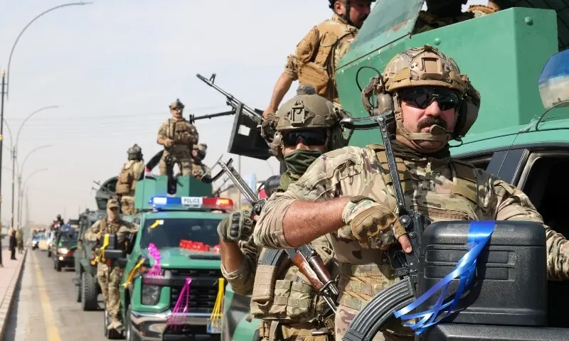 Members of the Iraqi security forces drive in a convoy through the city as they celebrate the withdrawal of US-led coalition forces from Iraq, ending a military presence that began after the 2003 US-led invasion, in Najaf, Iraq, September 30. — Reuters