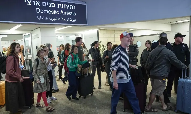 Passengers from an earlier diverted flydubai flight are seen after landing at Israel’s Ben Gurion Airport in Lod on September 30. – AFP