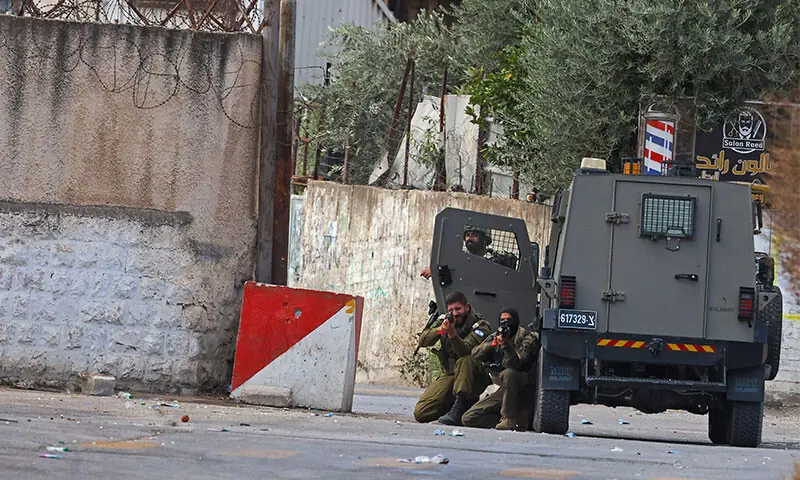 Israeli forces take position as settlers visit a sacred site in Nablus.—AFP Israeli forces take position as settlers visit a sacred site in Nablus.—AFP