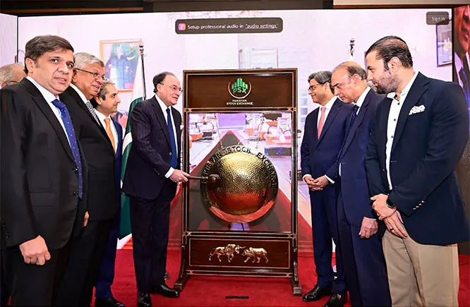 Finance Minister Muhammad Aurangzeb inaugurates the market session by ringing the traditional gong during his visit to Pakistan Stock Exchange.—Online Finance Minister Muhammad Aurangzeb inaugurates the market session by ringing the traditional gong during his visit to Pakistan Stock Exchange.—Online
