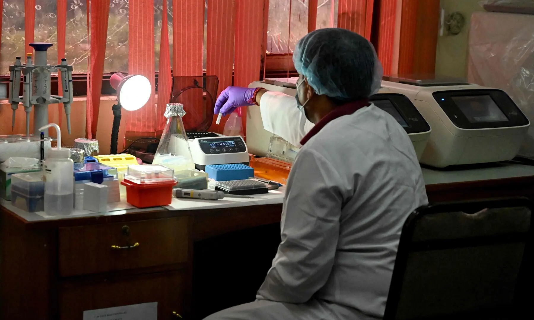 A forensic analyst conducts DNA testing to help identify missing flash flood victims at the National Forensic Science Laboratory in Lalitpur on September 19, 2026. —AFP/File
