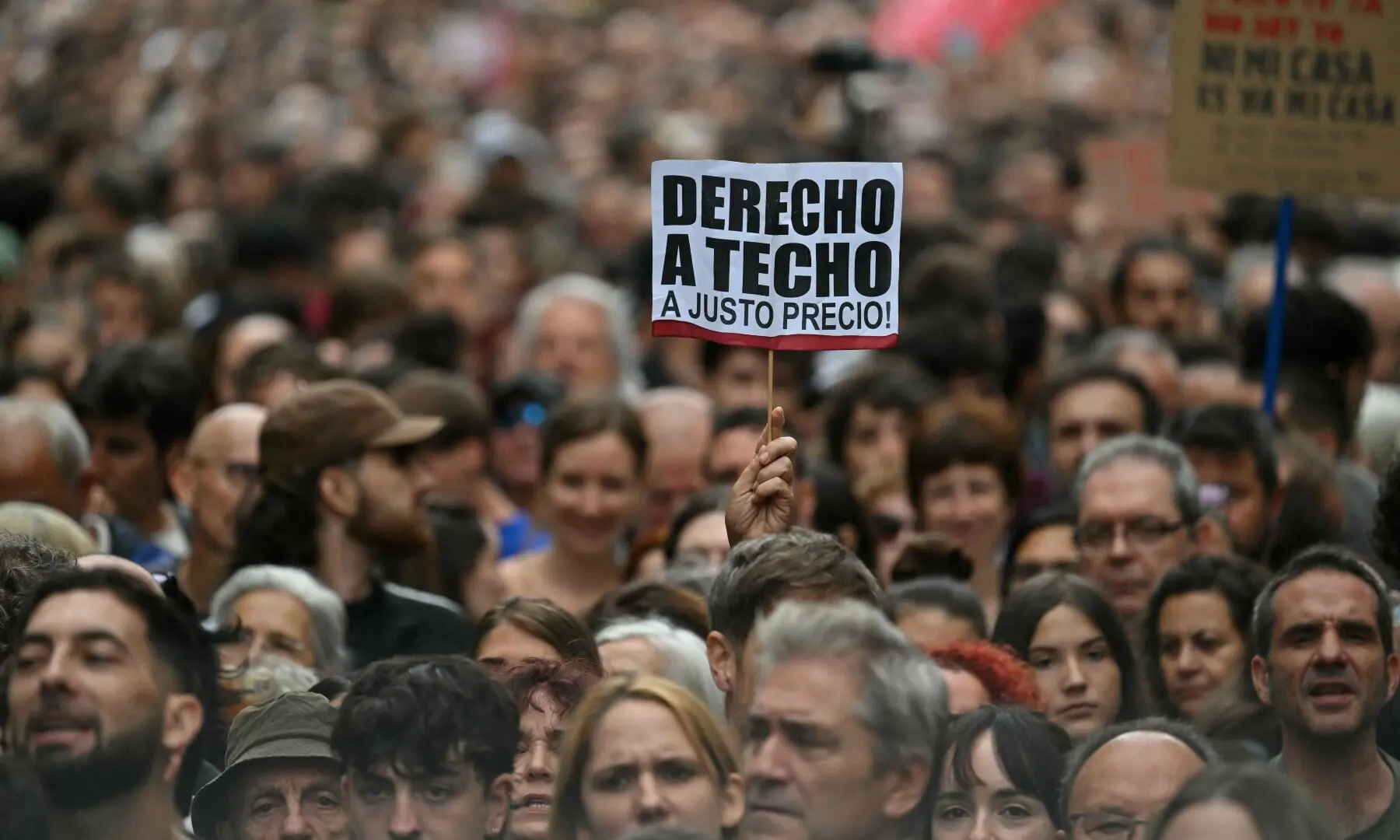 Demonstrators hold signs reading 'Right to a roof' during a protest against evictions and high rent prices on Plaza de Espana in Madrid, Spain on October 3, 2026. &mdash; AFP