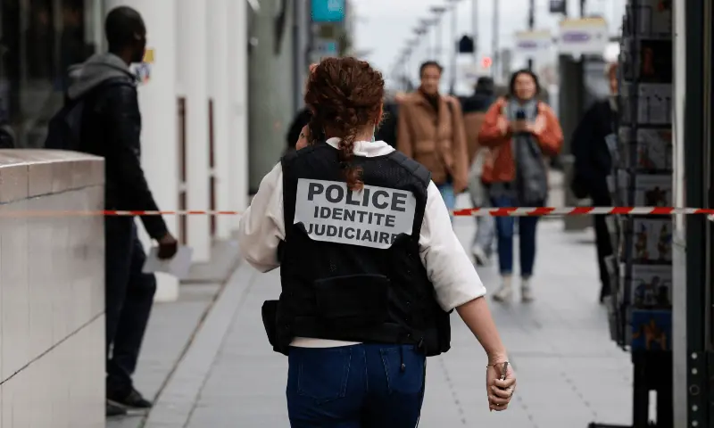 A French police officer wears a jacket, identifying herself as &ldquo;Police identite judiciaire&ldquo;, while walking from a metro station after a woman making threats on an RER train was shot and wounded by police, in Paris on October 31, 2023. &mdash; AFP/File