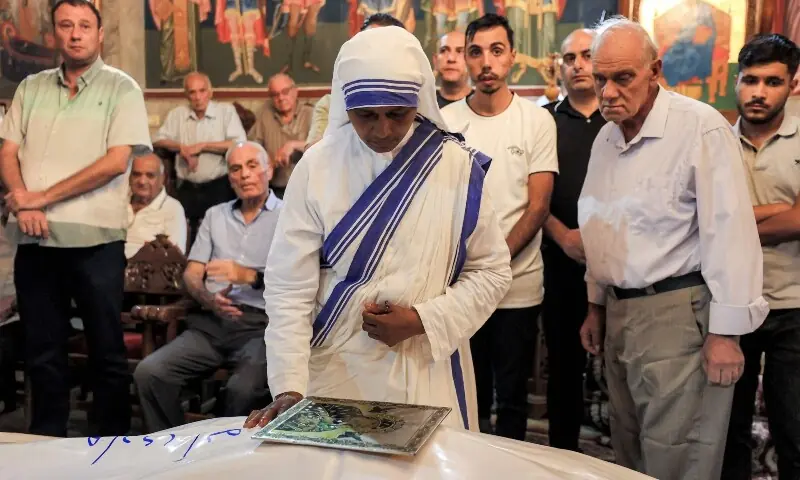 A nun prays before the bodies during the funeral of Maysaa Abu Daoud and her daughter Mary al-Najjar, who were killed following an Israeli strike on a residential building in the Rimal neighbourhood, at the Greek Orthodox Church of St Porphyrius in Gaza City’s Zaytoun neighbourhood on October 3, 2026. —AFP