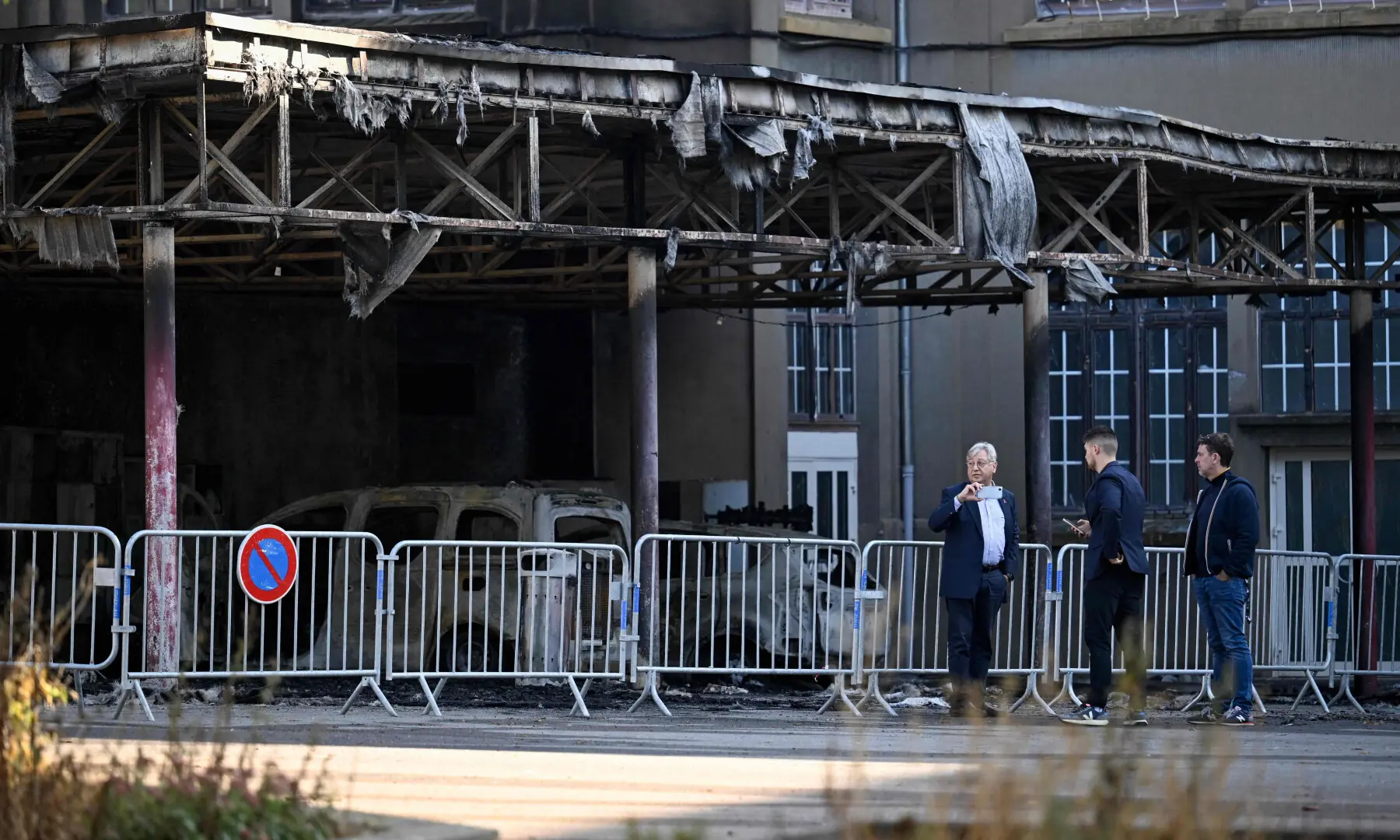 Mayor of Metz Francois Grosdidier (L) stands in front of burned vehicles belonging to staff members during a visit, at the Francois Rabelais secondary school, after the fire started last evening during students’ blockading action protest in Metz, northeastern France on Oct 3, 2026. — AFP