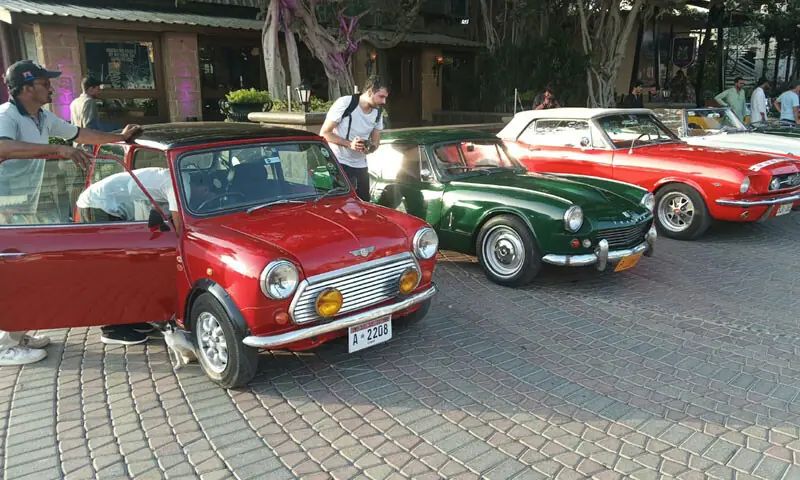 Classic cars gleam beneath the golden sunshine.&mdash; Dawn