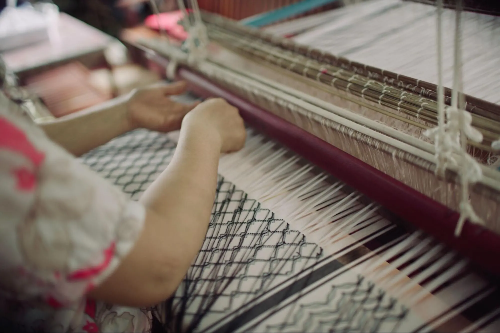 Weaving the keffiyeh made from traditional Lao mulberry silk.