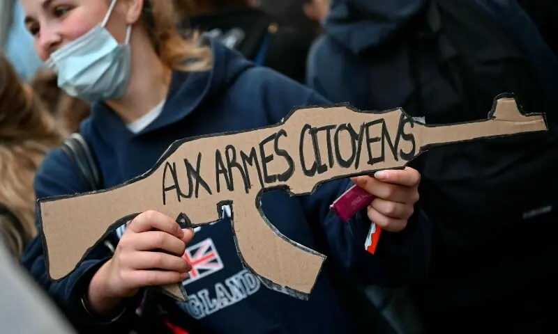 A pupil holds a placard reading “To arms, citizens” as protesting students carry out a blockading action at the Turgot secondary school, in Paris, on October 5, 2026. — AFP