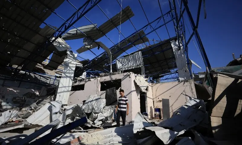 A Palestinian young man stands amid the debris of Al-Hassayna family company&rsquo;s warehouse, damaged during Israeli bombardment, in Gaza City on September 28, 2026. &mdash; Reuters