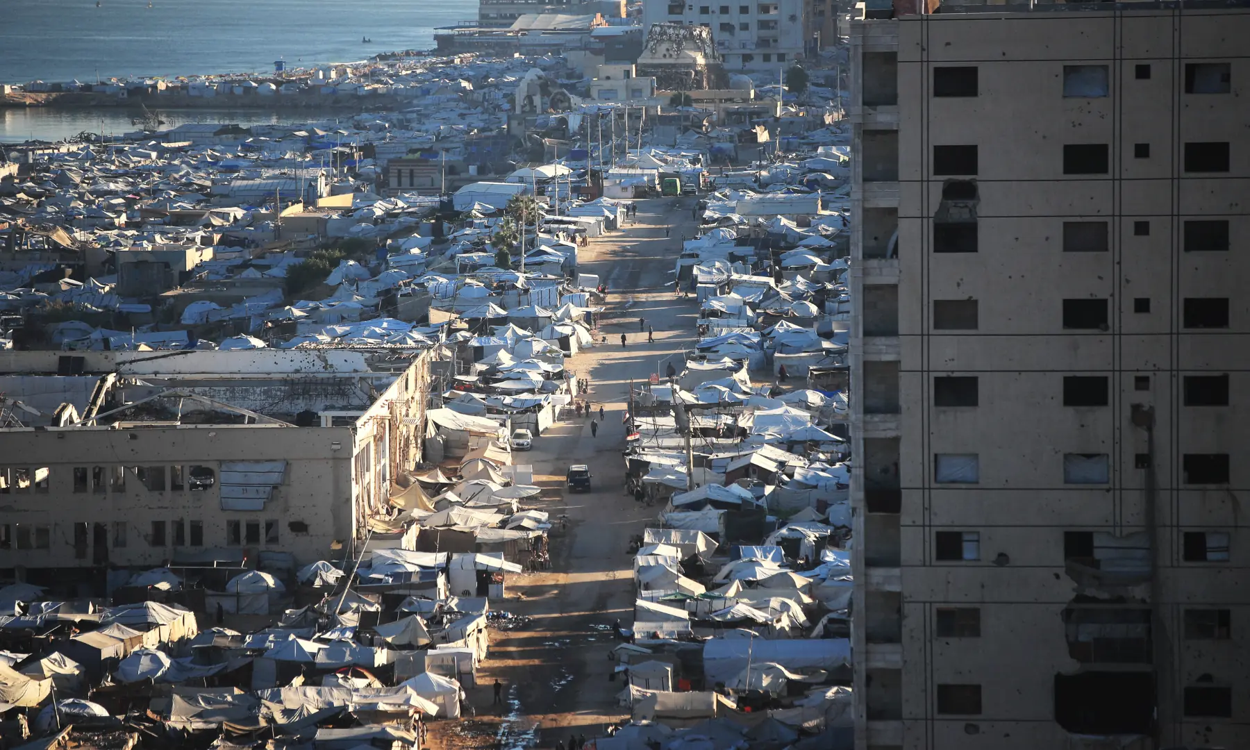 A view of the temporary tents of displaced Palestinians is pictured along destroyed buildings in Gaza City on Oct 7, 2026. &mdash; AFP