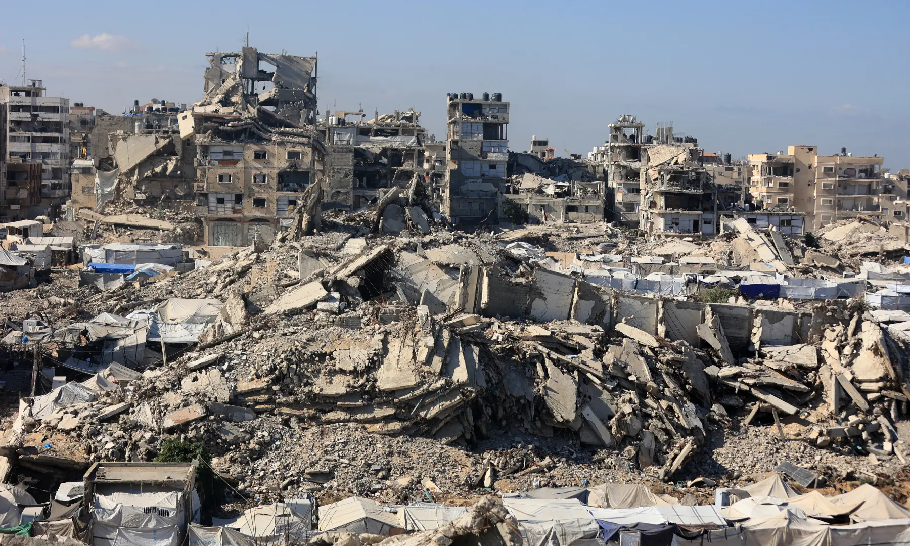A view of the temporary tents of displaced Palestinians is pictured along destroyed buildings in Gaza City on Oct 7, 2026. &mdash; AFP