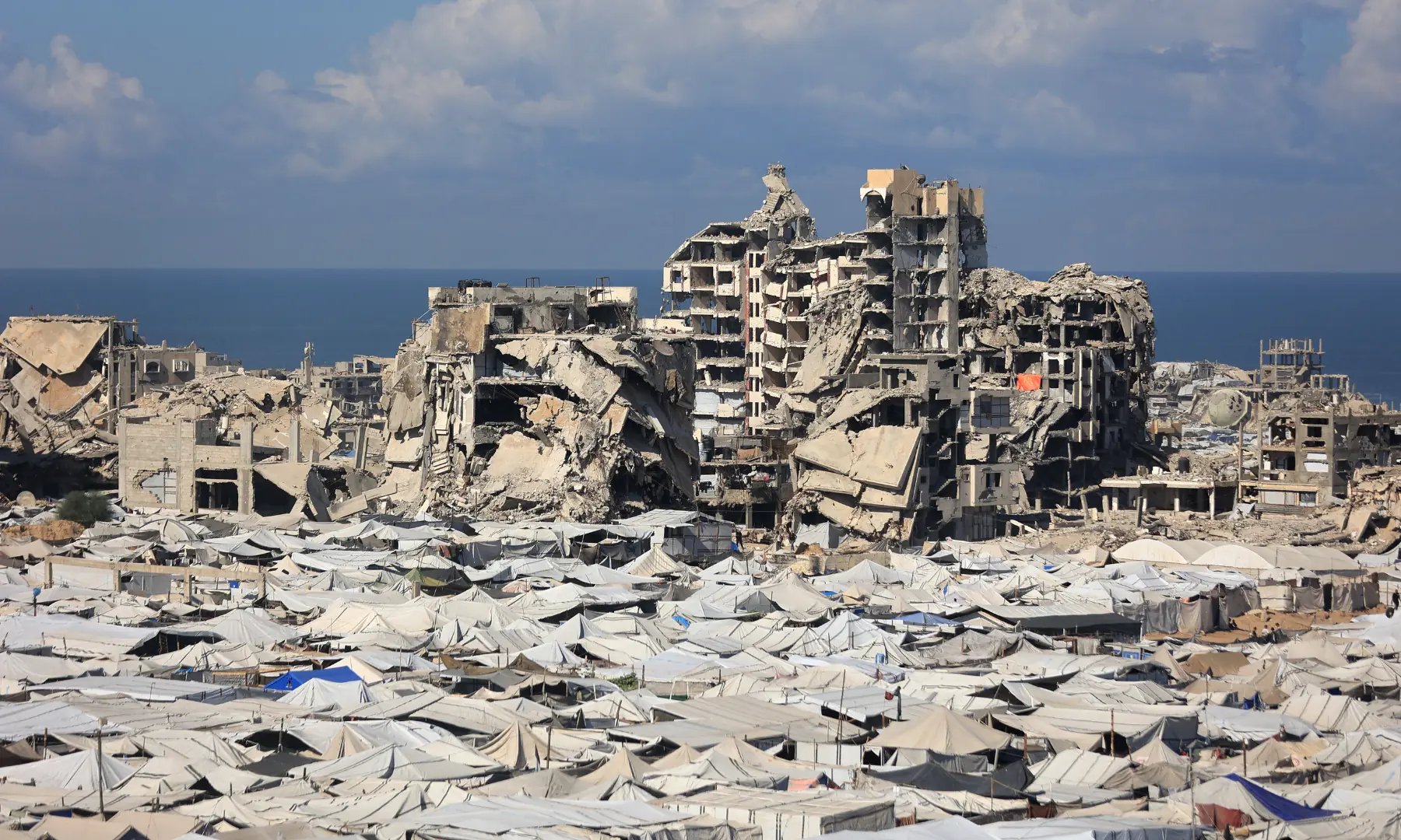 A view of the temporary tents of displaced Palestinians is pictured along destroyed buildings in Gaza City on Oct 7, 2026. &mdash; AFP