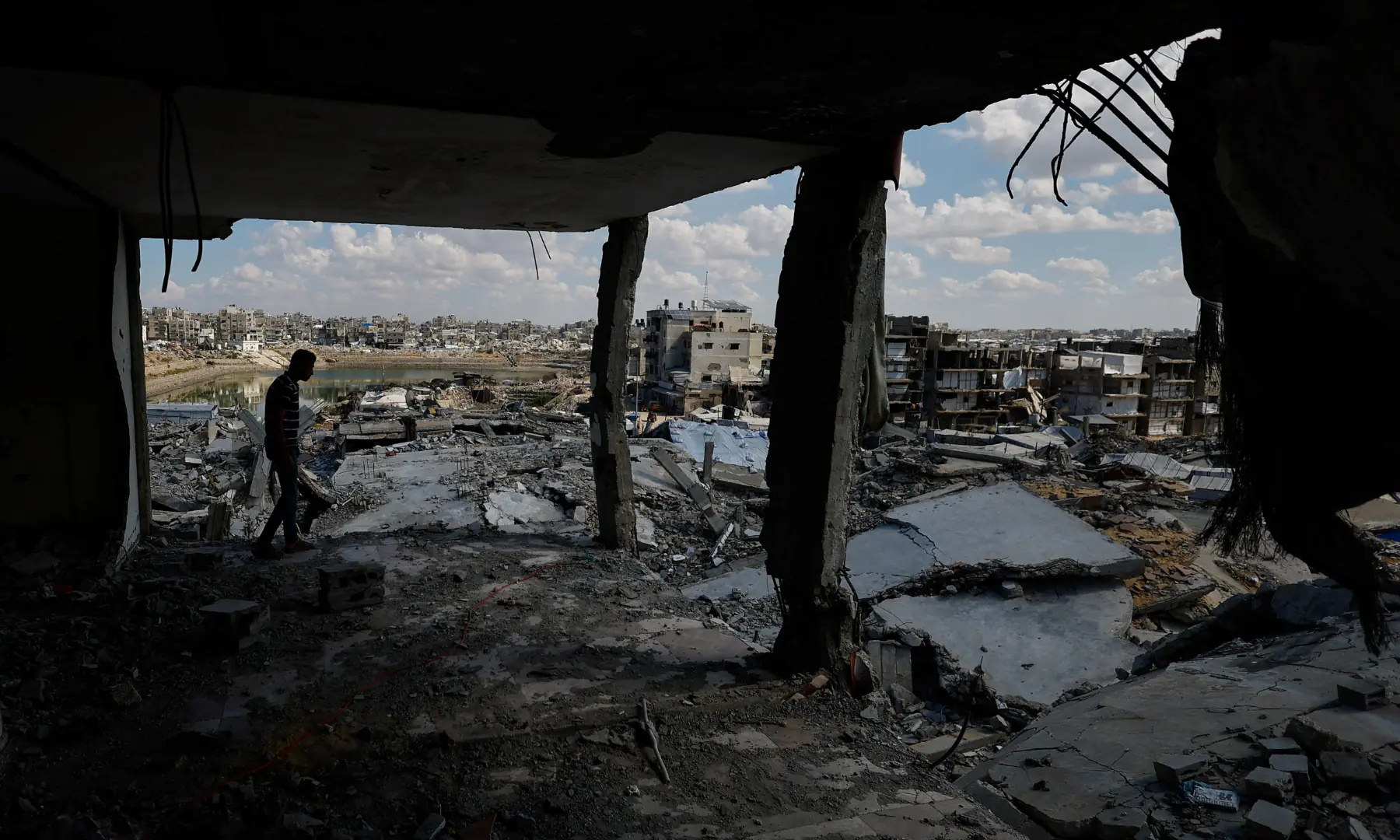 A Palestinian walks in the ruins of a building destroyed during the war, in Gaza City, on Oct 7, 2026. &mdash; Reuters