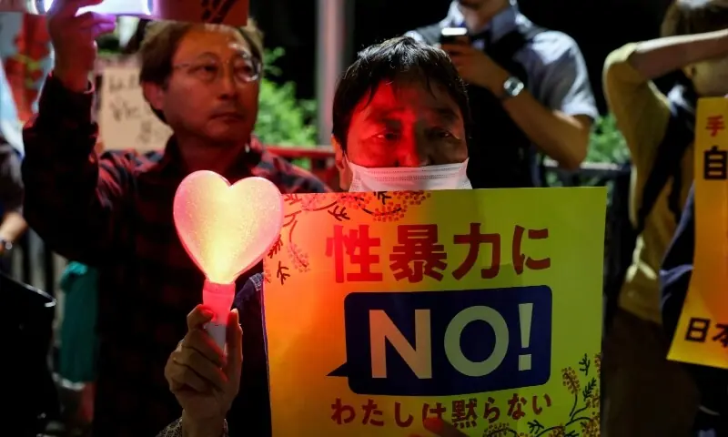 A demonstrator holds a placard during a protest outside the Prime Minister's office on October 5, following the killing of a Japanese woman in Okinawa. The placard reads: &ldquo;No to sexual violence&rdquo;. &mdash; Reuters