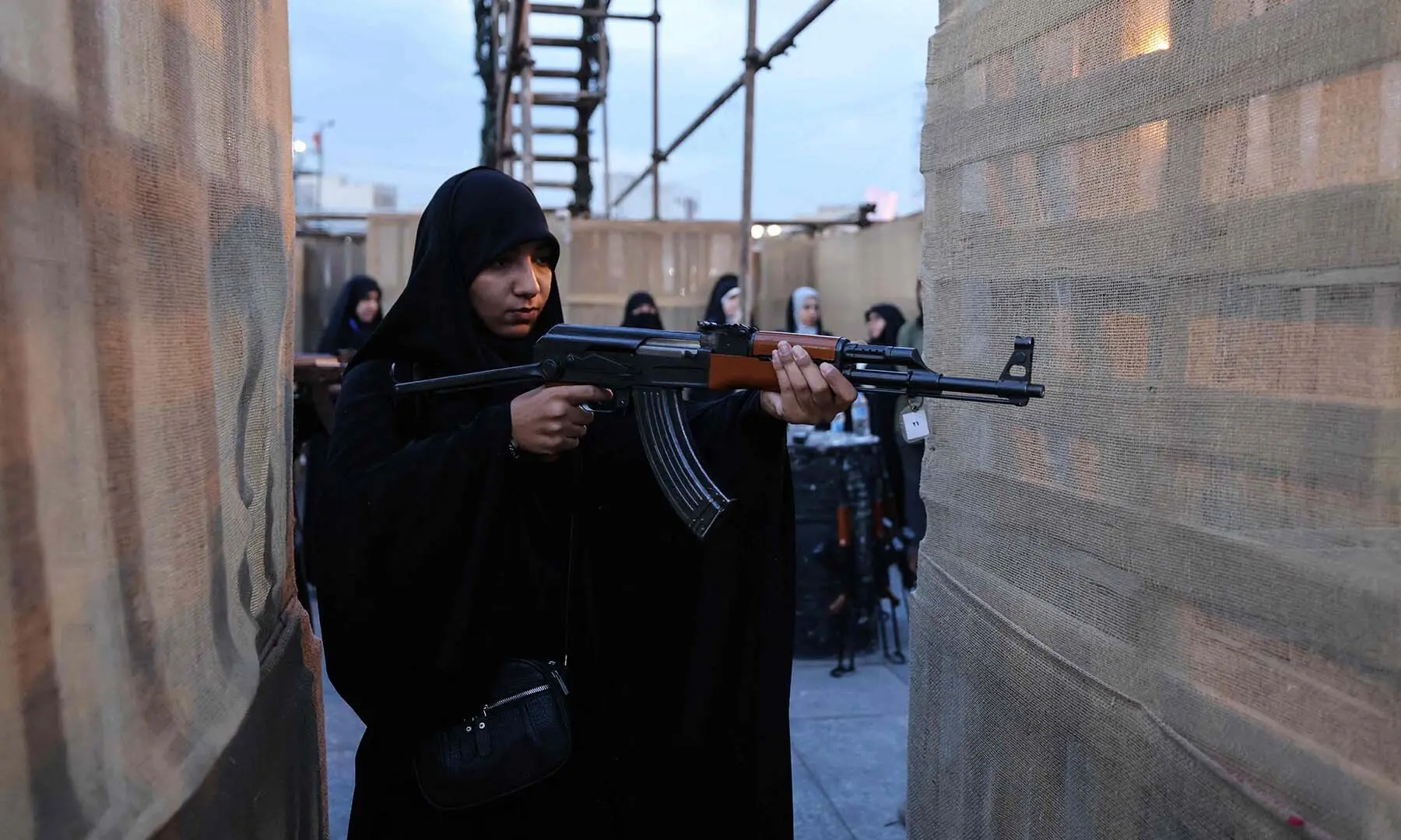 An Iranian woman aims a weapon during a military course for volunteers at the Janfada training camp set up in Imam Hussein square in Tehran, Iran on October 6, 2026. &mdash; AFP