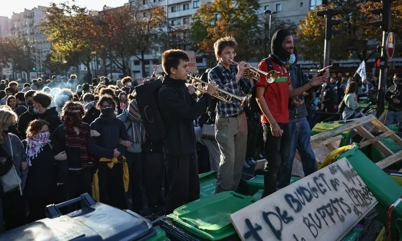 Police officers stand guard as French high school students block the road outside Lycee Helene-Boucher high school, as part of nationwide protests to demand better school conditions in Paris, France, October 8, 2026. —Reuters