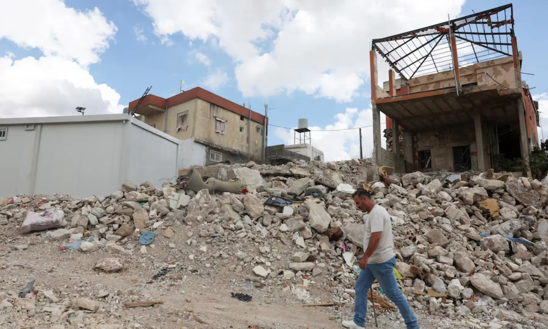 A man walks next to damaged homes in West Zawtar, southern Lebanon, on Oct 1, 2026. — Reuters