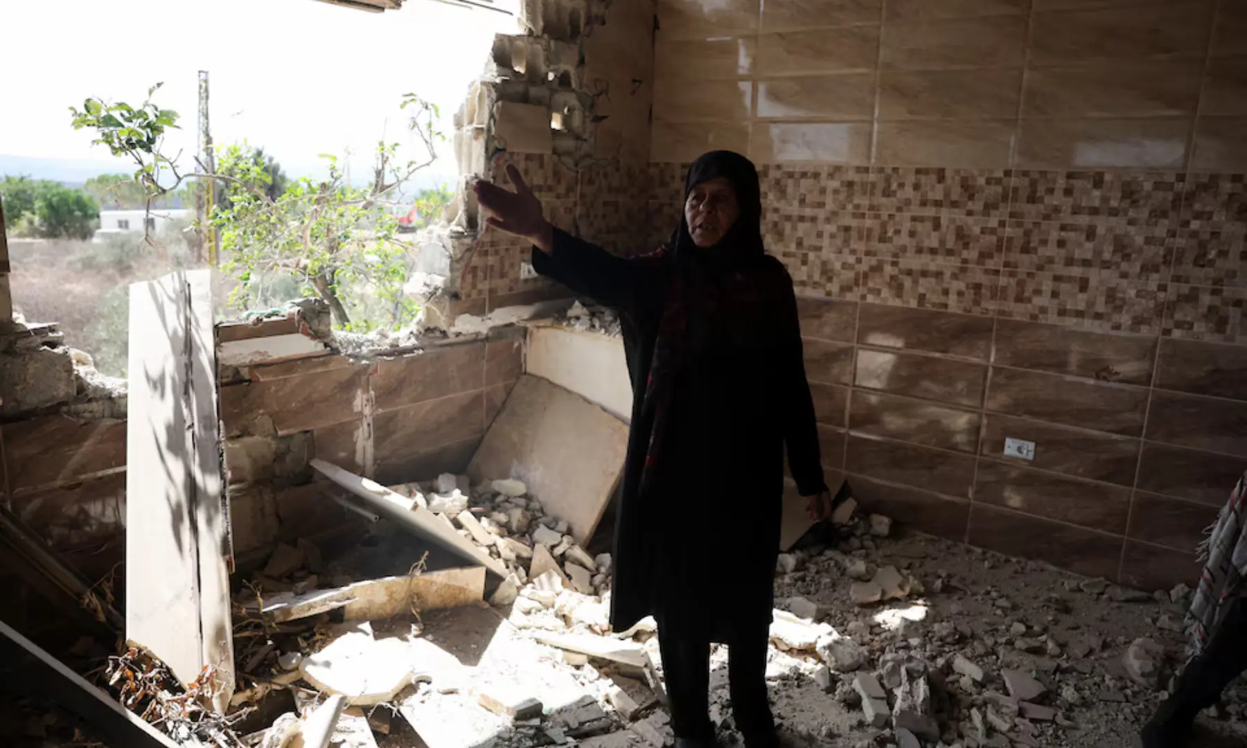 Mariam al-Yaghi , 67, Lebanese resident from West Zawtar, stands in her damaged house in southern Lebanon, on Oct 1, 2026. — Reuters