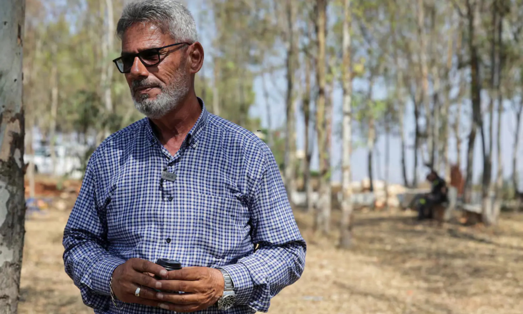 Mayor of Zawtar Al-Gharbiyeh, Abed Ezzedin, stands in the outskirts of the village as he waits to return to his hometown, in southern Lebanon, on July 23, 2026. — Reuters