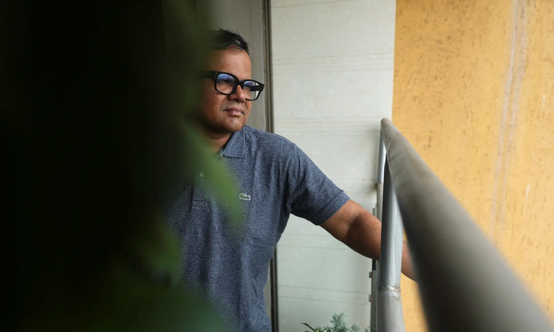 Tushar Shetty, a resident of the Lodha Luxuria residential complex, looks towards the site of an Amazon data centre from the balcony of his home in Thane, India on September 22, 2026. —Reuters
