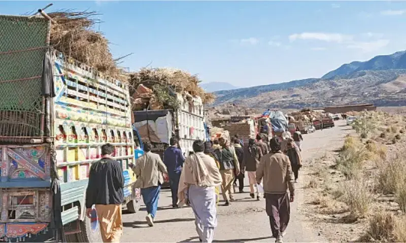 Tirah residents with their personal belongings loaded on trucks just before leaving the valley. &mdash; Dawn