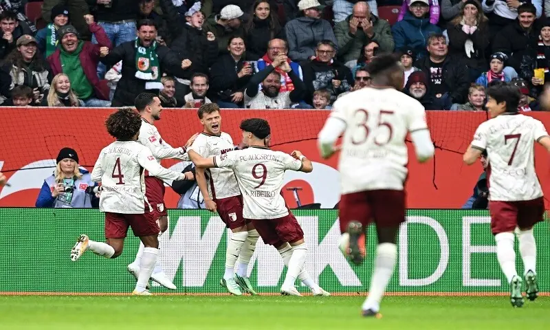 Augsburg's Robin Fellhauer (third L) celebrates with team-mates after scoring against Bayern Munich during their Bundesliga match at the WWK Arena in Augsburg on October 10, 2026.—Reuters Augsburg's Robin Fellhauer (third L) celebrates with team-mates after scoring against Bayern Munich during their Bundesliga match at the WWK Arena in Augsburg on October 10, 2026.—Reuters