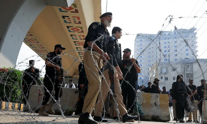 Police guard a road leading to Red Zone, in Peshawar on October 11, 2026. — Reuters