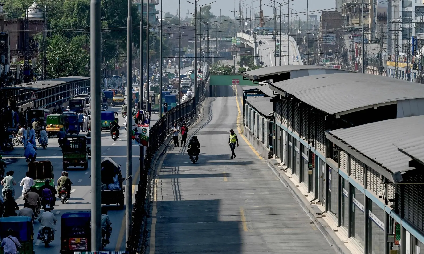 A bus rapid transit lane (R) is seen deserted during a security lockdown following the imposition of emergency and governor&rsquo;s rule in KP on October 12. &mdash;Reuters