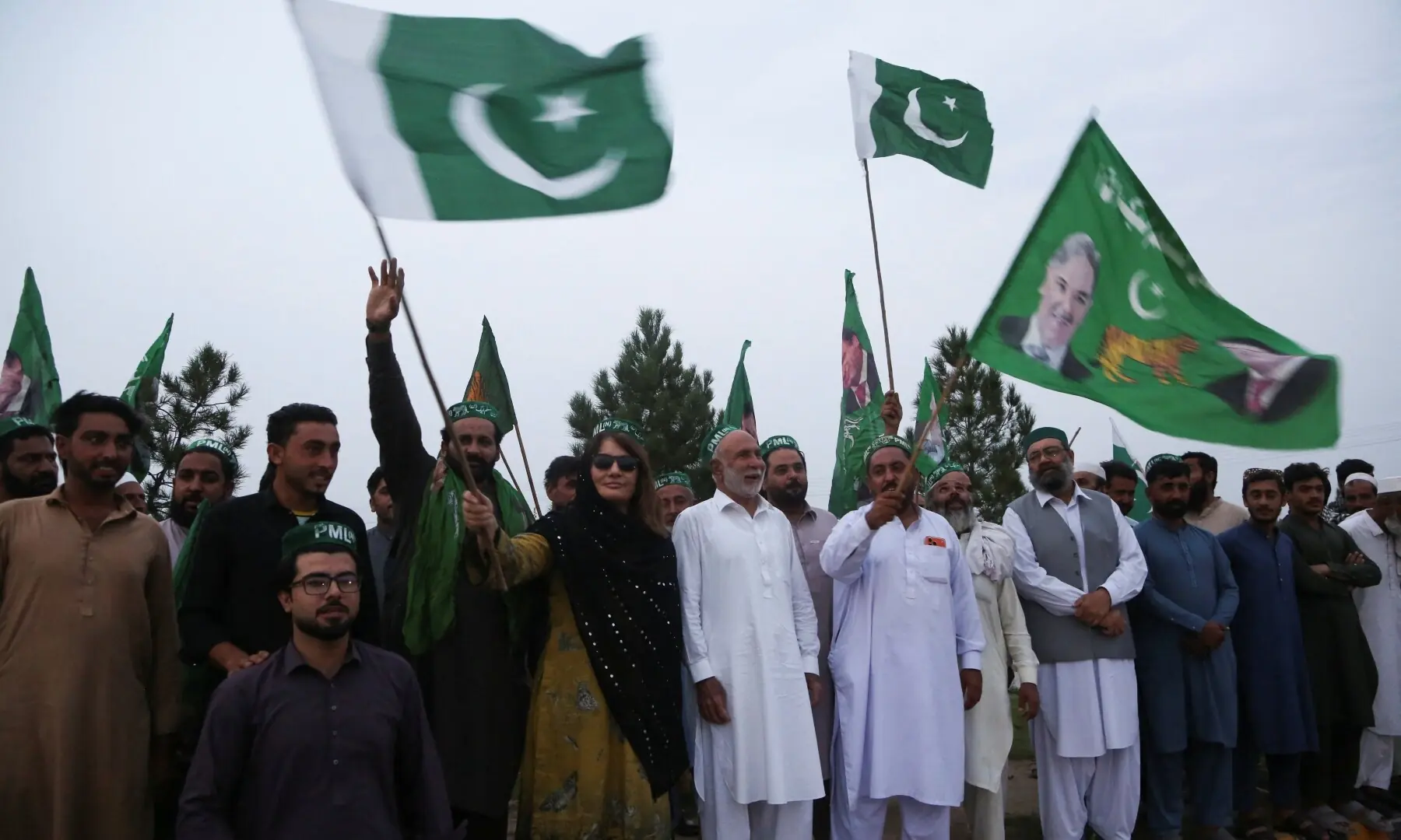 PML-N supporters wave flags as they celebrate, after an emergency was declared in KP on October 11, 2026. &mdash;Reuters