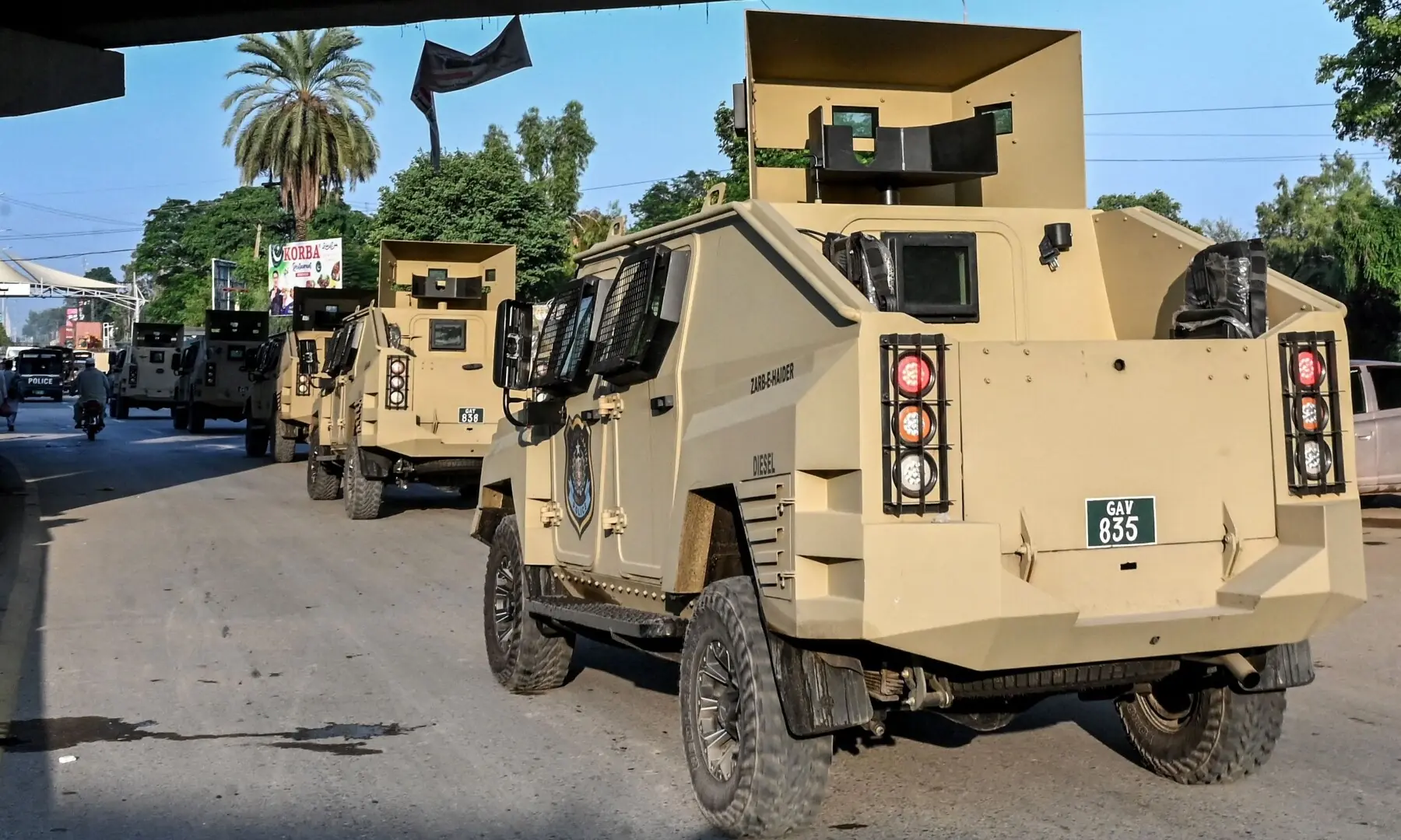 Armoured police vehicles drive along a road as security tightened after the imposition of emergency and governor&rsquo;s rule in KP on October 12, 2026. &mdash;Reuters
